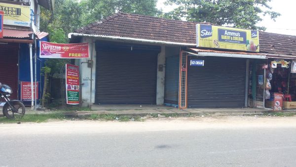 2 cent with shops and lodge east of kalavoor junction roadside .No brockers negotiable